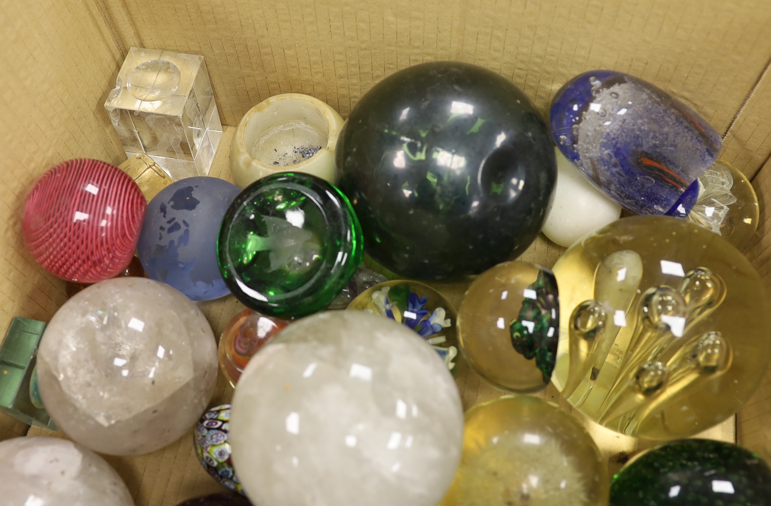 A collection of thirty three mixed glass and stone paperweights and three quartz balls